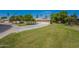 Inviting home with lush front lawn and mature trees with a private two-car garage at 10644 W Campana Dr, Sun City, AZ 85351