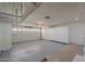Organized garage featuring epoxy floors, built-in storage cabinets, and a clean, spacious layout for vehicles and projects at 10644 W Campana Dr, Sun City, AZ 85351