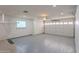 Clean garage featuring epoxy floors, white walls, built in storage cabinets, and a garage door opener at 10644 W Campana Dr, Sun City, AZ 85351