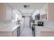 Modern kitchen featuring white cabinets, sleek countertops, stainless steel appliances, and a stylish tile backsplash at 10644 W Campana Dr, Sun City, AZ 85351