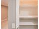 Open linen closet with shelves and a light gray interior wall and baseboard at 10644 W Campana Dr, Sun City, AZ 85351