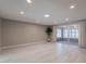 Expansive room with sleek floors, neutral walls, recessed lighting, and sliding glass doors to a private patio at 10644 W Campana Dr, Sun City, AZ 85351