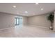 Bright living room with recessed lighting, white floors, and neutral walls at 10644 W Campana Dr, Sun City, AZ 85351