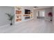 Bright living room with built in shelving and fireplace, along with a skylight at 10644 W Campana Dr, Sun City, AZ 85351