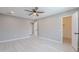 Bright main bedroom showcasing wood-look floors, neutral walls and multiple doors at 10644 W Campana Dr, Sun City, AZ 85351