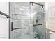 Updated shower with glass doors, matte black hardware, and modern tile detail at 10644 W Campana Dr, Sun City, AZ 85351