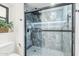 Newly remodeled walk-in shower boasts marble tile, and sleek black hardware at 10644 W Campana Dr, Sun City, AZ 85351