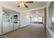 Spacious sunroom with neutral carpet, and sliding glass doors that lead to another room for flexible living at 10644 W Campana Dr, Sun City, AZ 85351