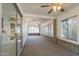 Large sunroom with many windows, brick accents, and sliding glass doors, offering plenty of natural light at 10644 W Campana Dr, Sun City, AZ 85351