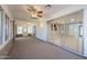 Bright sunroom featuring sliding glass doors, ample windows, brick accent walls, and ceiling fans for year-round comfort at 10644 W Campana Dr, Sun City, AZ 85351
