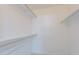 A walk-in closet offers lots of storage space with shelves and hanging rods at 10644 W Campana Dr, Sun City, AZ 85351