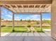 Spacious covered patio overlooks the golf course, featuring stepping stones and artificial grass at 11547 W King Snake Ct, Surprise, AZ 85378