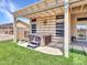 Backyard featuring a hot tub, artificial grass, and pavers at 11547 W King Snake Ct, Surprise, AZ 85378