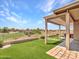 A serene backyard featuring artificial grass, desert landscaping and golf course views at 11547 W King Snake Ct, Surprise, AZ 85378