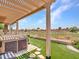 Well-manicured backyard featuring a hot tub, desert landscaping and artificial grass at 11547 W King Snake Ct, Surprise, AZ 85378