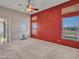 A bedroom has a ceiling fan, carpet, and side view entry door at 11547 W King Snake Ct, Surprise, AZ 85378