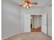 Bedroom showcasing a fan, plush carpet flooring, and a doorway leading to another room at 11547 W King Snake Ct, Surprise, AZ 85378