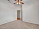 Neutral bedroom with plush carpet flooring, a ceiling fan, and a doorway leading to another room at 11547 W King Snake Ct, Surprise, AZ 85378