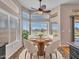 Bright dining area features bay windows, ceiling fan, and seating for four at 11547 W King Snake Ct, Surprise, AZ 85378