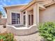Inviting front entrance with tiled porch and lush landscaping at 11547 W King Snake Ct, Surprise, AZ 85378