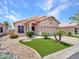 Charming single-story home featuring well-manicured landscaping and a welcoming entrance at 11547 W King Snake Ct, Surprise, AZ 85378