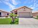 Well-maintained single-story home showcases a two-car garage and a tidy front yard at 11547 W King Snake Ct, Surprise, AZ 85378