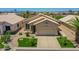 Inviting single-story home with desert landscaping, a two-car garage, and a charming front patio at 11547 W King Snake Ct, Surprise, AZ 85378