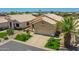 Well-maintained home featuring desert landscaping with green turf accents and a spacious driveway at 11547 W King Snake Ct, Surprise, AZ 85378