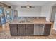 Updated kitchen with stainless steel dishwasher and sink, seamlessly blending with dining area at 11547 W King Snake Ct, Surprise, AZ 85378