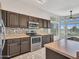 Kitchen featuring stainless steel appliances, dark wood cabinets and designer backsplash at 11547 W King Snake Ct, Surprise, AZ 85378