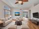 Comfortable living room with hardwood floors, ceiling fan, and modern furnishings at 11547 W King Snake Ct, Surprise, AZ 85378