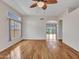 Spacious living room featuring hardwood floors, arched doorway, and large windows at 11547 W King Snake Ct, Surprise, AZ 85378