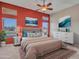 This staged primary bedroom features a ceiling fan and luxury decor at 11547 W King Snake Ct, Surprise, AZ 85378