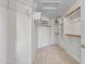 Spacious walk-in closet features built-in shelving, ample hanging space, and carpet flooring at 11547 W King Snake Ct, Surprise, AZ 85378