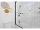 Bathroom with a white subway tile shower, modern fixtures, and stylish woven wall decor at 13020 N 18Th St, Phoenix, AZ 85022