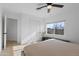 Serene bedroom with a comfortable bed, light wood floors, ceiling fan and picturesque window view at 13020 N 18Th St, Phoenix, AZ 85022
