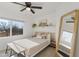 Cozy bedroom with a neutral palette, ceiling fan, and natural light for a serene retreat at 13020 N 18Th St, Phoenix, AZ 85022