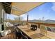 Enjoy a meal with a view on this wooden deck with large dining table and peaceful scenery at 13020 N 18Th St, Phoenix, AZ 85022