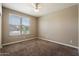 Bright bedroom with plush carpet, a large window offering natural light, and neutral walls, providing a calming atmosphere at 13612 W Desert Moon Way, Peoria, AZ 85383