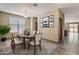 Inviting dining room features modern chandelier, wall art, and bright natural light at 13612 W Desert Moon Way, Peoria, AZ 85383