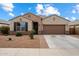 Charming single-story home with a desert landscape, two-car garage and covered entry at 13612 W Desert Moon Way, Peoria, AZ 85383