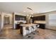 Stylish kitchen with granite countertops, dark cabinetry, and island with seating at 13612 W Desert Moon Way, Peoria, AZ 85383