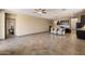Bright and airy living room next to kitchen with neutral paint and tile floors at 13612 W Desert Moon Way, Peoria, AZ 85383
