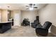 Comfortable living room with tile flooring, neutral colors, and an area for a home office at 13612 W Desert Moon Way, Peoria, AZ 85383
