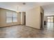 Spacious living room with tile flooring, neutral paint, and natural light at 13612 W Desert Moon Way, Peoria, AZ 85383