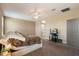 Spacious bedroom with an attached ensuite bathroom, ceiling fan, and a comfortable, cozy atmosphere at 13612 W Desert Moon Way, Peoria, AZ 85383