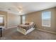Spacious, sunlit bedroom features neutral walls, plush carpet, and large windows that bring in natural light at 13612 W Desert Moon Way, Peoria, AZ 85383