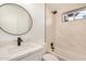 Modern bathroom with white marble tile, black fixtures, and large mirror at 1368 W 14Th St, Tempe, AZ 85281