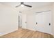 Well-lit bedroom features a ceiling fan and modern white closet and trim at 1368 W 14Th St, Tempe, AZ 85281