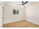 Bedroom with a ceiling fan, light hardwood floors, and a large window at 1368 W 14Th St, Tempe, AZ 85281